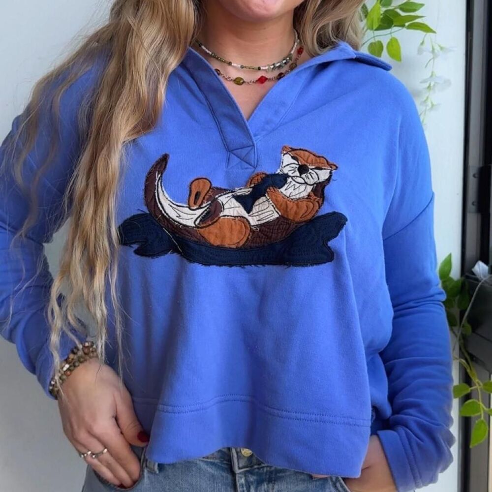 Upcycled otter with fish patchwork embroidered collared blue sweatshirt